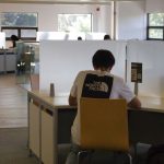 A person sitting at a desk with a laptop